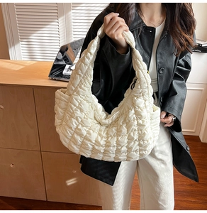 Détail du sac hobo matelassé blanc avec large bandoulière et fermeture à glissière