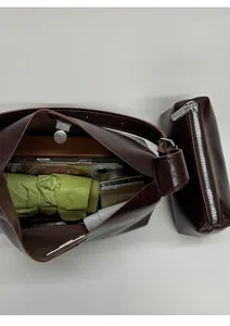 Detail of dark brown leather tote bag with small zipper pouch and spacious daily storage