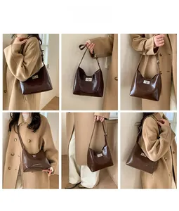 Detail view of the brown leather handbag showing silver turn-lock and multiple carrying styles