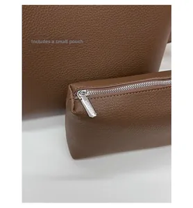 Detail of brown litchi pattern leather bag set with matching zippered inner pouch