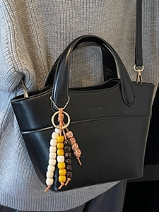 Vintage black leather bucket bag for women with colorful beaded pendant and strap