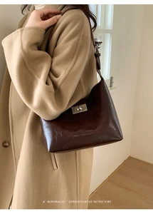 Detailed view of deep chocolate brown vintage hobo bag with silver metallic twist lock