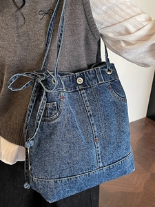 Vintage blue denim tote bag with metal buttons and decorative side ribbon bow