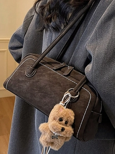 Brown suede underarm shoulder bag with contrast stitching and cute plush dog charm