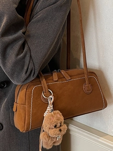 Brown suede underarm shoulder bag with white contrast stitching and cute dog charm