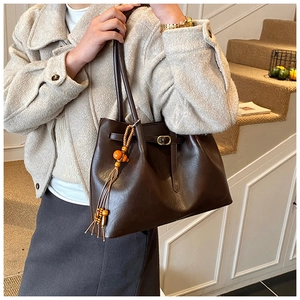 Gros plan du sac cabas rétro marron foncé en cuir mat avec pampille de perles élégante