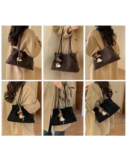 Detail view of large faux suede tote bags in coffee and black with leopard heart charms