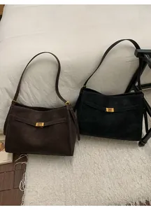 Close-up of matte vintage tote bag with gold buckle detail and warm aesthetic