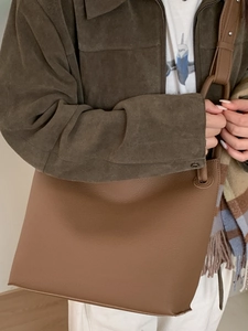 Brown litchi grain leather bucket tote bag with minimalist shoulder strap for women