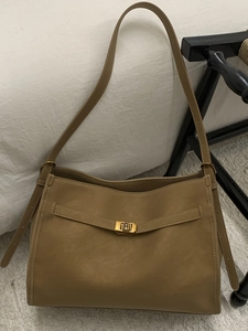 Minimalist tan leather tote bag with gold metal square twist lock and long shoulder strap