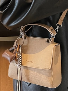 Khaki pebbled leather handbag with top handle and crossbody strap for chic commuting