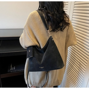 Mannequin portant un sac hobo noir avec coutures contrastées et porte-cartes