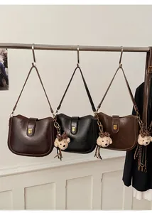 Three sleek PU leather saddle bags in brown and black with cute bear charms