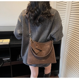 Détail d'un grand sac cabas vintage marron avec petite pochette et logo imprimé