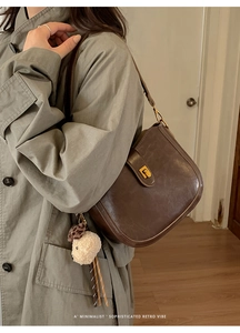 Brown retro leather saddle bag featuring a gold buckle and cute lamb charm on the strap