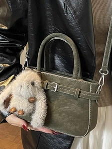 Retro dark green matte handbag with decorative buckle and plush bunny charm detail