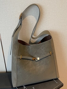 Minimalist matte grey-green leather bucket tote bag with gold buckle and strap detailing