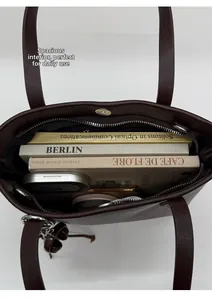 Macro view of the large capacity interior of this dark brown leather bucket bag