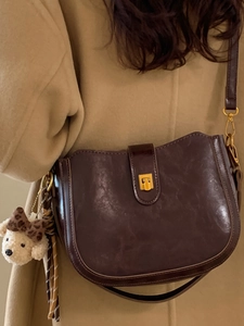 Retro dark brown leather bucket bag with gold clasp and cute teddy bear charm