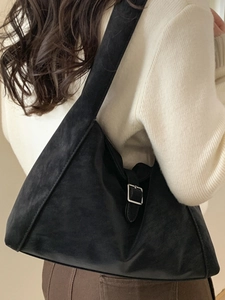 Minimalist black hobo shoulder bag in faux suede with vintage silver buckle detail