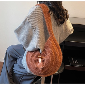 Close-up of brown fuzzy knit tote bag featuring a cream rope and horn button closure