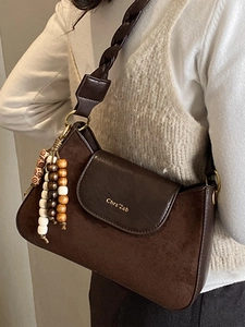 Fashionable dark brown crossbody bag with suede stitching and woven strap detail