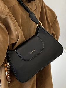 Classic black leather crossbody flap bag with golden logo and beaded charm for daily work