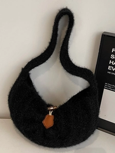Minimalist black faux fur hobo tote bag with a vintage horn button and soft plush texture