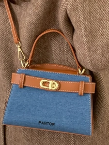 Chic blue denim and brown leather handbag with gold twist lock and PANTOR print