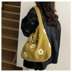Detailed texture of ginger plush tote bag with white flower embroidery and soft handle