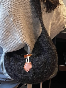 Black plush knit tote bag with horn buckle and leather tag for winter outfits