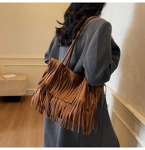 Detailed back view of brown suede tote bag with fringe tassels and large capacity