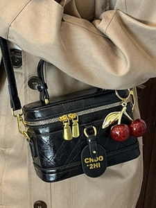 Quilted black box crossbody bag with red cherry charm and gold metal zipper hardware