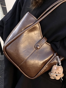 Minimalist dark brown oil wax leather shoulder bag with glossy finish and cute puppy charm