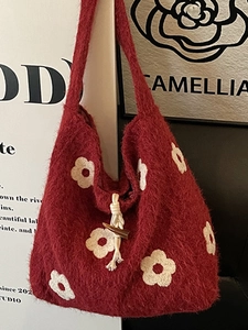 Red plush tote bag with white flower embroidery and vintage toggle closure strap