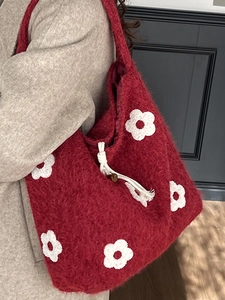 Plush burgundy tote bag with white flower embroidery and faux mohair texture
