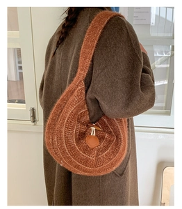 Detail of soft brown knit tote bag showing plush texture and horn button closure