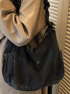 Retro washed denim hobo bag in black with ruffled shoulder strap and metal logo