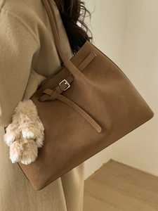 Brown vintage suede tote bag with plush bunny charm and silver buckle detail