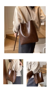 Detail view of brown vintage leather bucket bag set showing texture and inner pouch