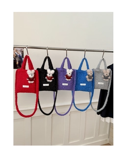 Detailed view of plush teddy bear tote bags in red, black, purple, blue and grey colors