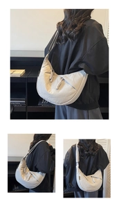 Detail of grey half-moon canvas bag featuring woven rope zipper and branded side label