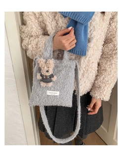 Detail of grey plush tote bag featuring a cute fuzzy bear and soft knit shoulder strap