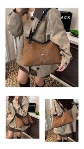 Detailed macro view of brown faux suede texture and artistic embroidery on the shoulder bag