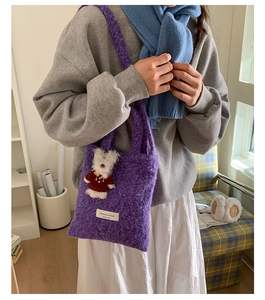 Detail of purple faux shearling tote bag featuring a cute 3D teddy bear ornament decoration