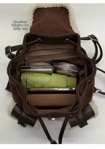 Internal view of the plush brown tote bag showing large capacity and striped lining