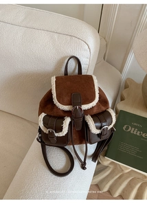 Detail of retro plush tote bag with brown suede texture and cream faux fur trim detailing