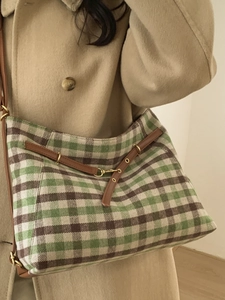 Green and beige plaid shoulder bag with brown leather straps and gold metal hardware