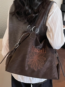 Chocolate brown large tote bag with floral embroidery and silver metal ring straps