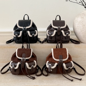 Close-up of retro mini backpacks with warm plush shearling trim and faux leather texture